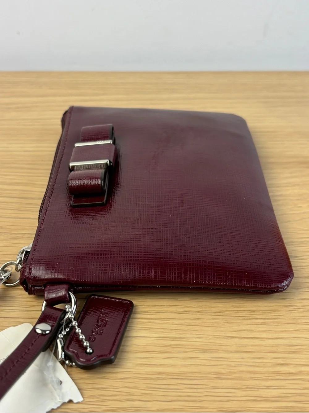 Coach Darcy Patent Leather Bow Small Wristlet in “Sherry” Wine Color NWT